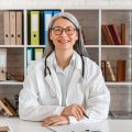happy-middle-aged-woman-doctor-sitting-at-the-desk-2022-07-06-23-03-01-utc.jpg