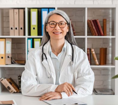 happy-middle-aged-woman-doctor-sitting-at-the-desk-2022-07-06-23-03-01-utc.jpg