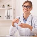 smiling-doctor-woman-holding-prescribed-medication-2022-12-16-08-49-38-utc.jpg